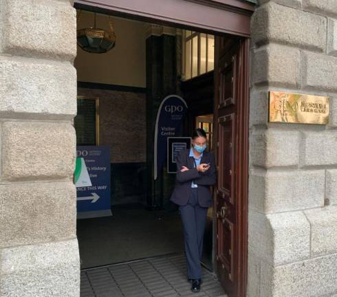 At the GPO Museum in Dublin, a guard stands at the door to make sure that visitors follow mandated COVID requirements. Photo: Ralph Spielman