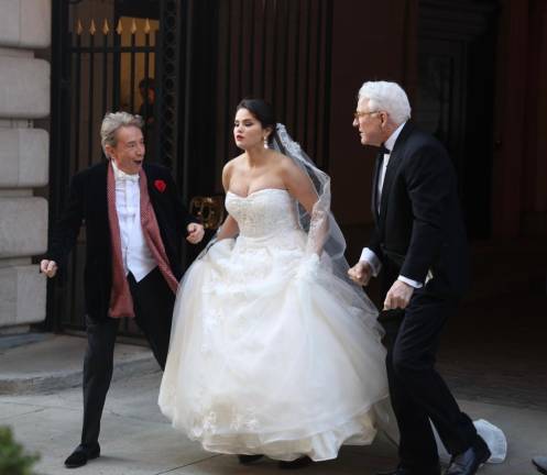 In a possible hint of what is in store for the next season of Hulu’s hit “Only Murders in the Building,” Selena Gomez, who plays Mable Mora, is captured by paparazzi in a stunning wedding dress as she exits the fictional Arconia Building on W. 86th and Broadway. Photo: Steve Sands/New York Newswire