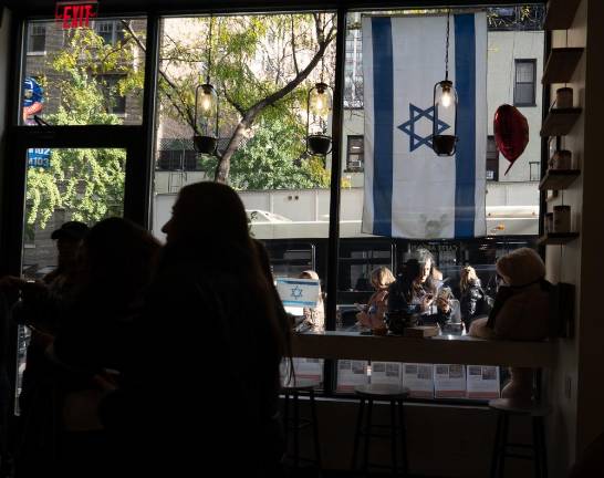 Following recent support, the owner displays a large Israeli flag on the cafe's front window. (Priyanka Rajput)