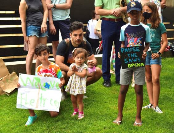 Children display their signs to save the green space at Rockefeller Park. Photo: Emily Higginbotham