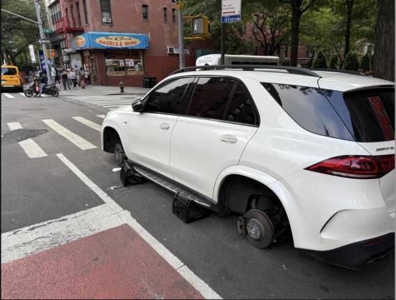 In the light of day: the stripped car (incident No. 13) resting on milk crates.