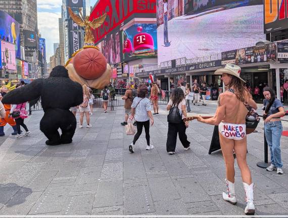 It’s a Hot Dog! It’s Art! It’s on display in Duffy Square through August 8, sometimes with Naked Cowboy.