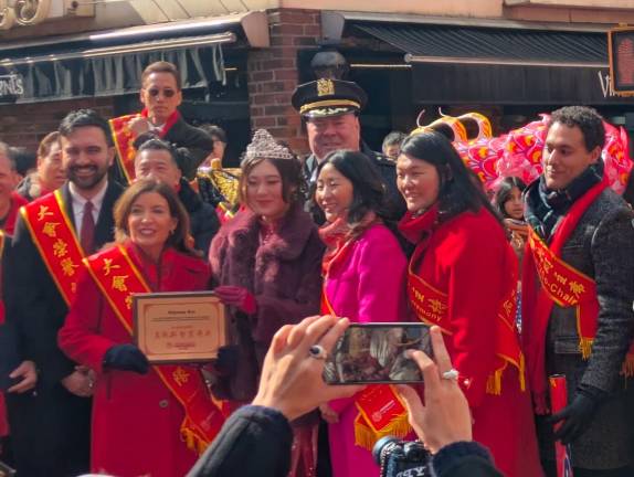 Solons, and a large cop, on the dais at the Chinatown Lunar New Year Parade.