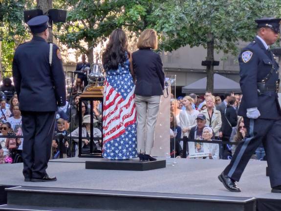 A woman in a flag dress during her turn in the reading of the names.
