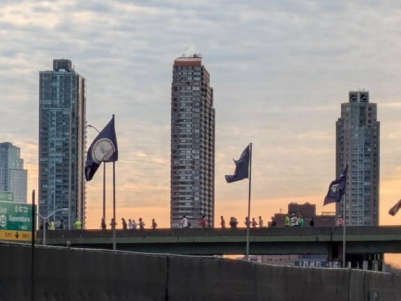 NYC Half Marathon runners on the FDR Drive, Queens behind them.