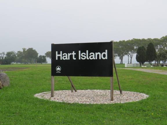 Upon reaching Hart Island, the usual NYC Parks Department green and white signage is a somber black and white, noting the resting place of many.