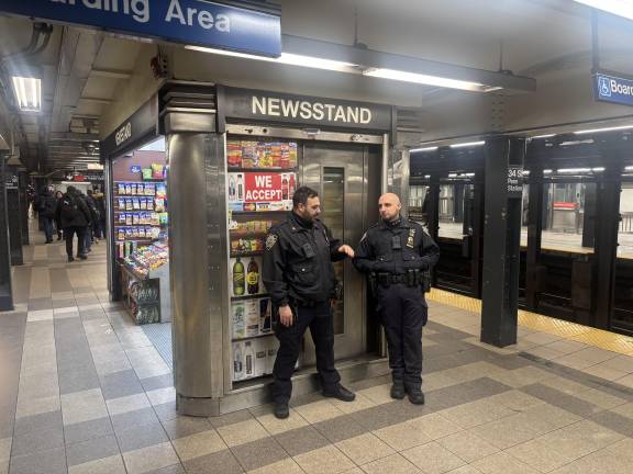 Gov. Hochul is proposing to allocated $77 million to extend the police surge in NYC subways so that every train running from 9 p.m. to 5 a.m. has two cops on board. Cops above were at the 7th Ave. Penn Station stop.
