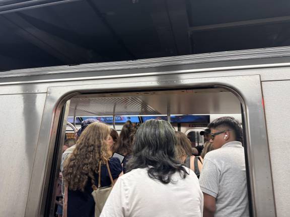 Due to fewer trains running on time if at all, commuters cram onto the remaining available trains.