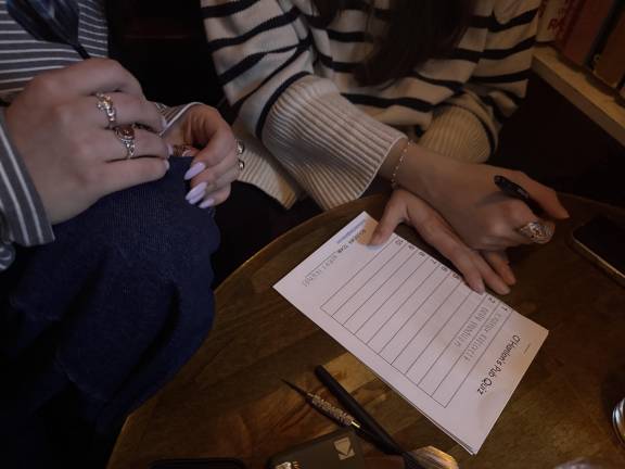 Patrons at O’Hanlon’s get ready to record answers during the pub’s weekly trivia contest hosted by Pete Sullivan, aka Quizmaster Pete.