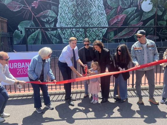 City Council Member Erik Bottcher (center, tie), Yourban2030 founder Veronica de Angelis (helping child with scissors), Fabio Petani (artist, jean jacket), and an adorable tot cut the ribbon for the mural.