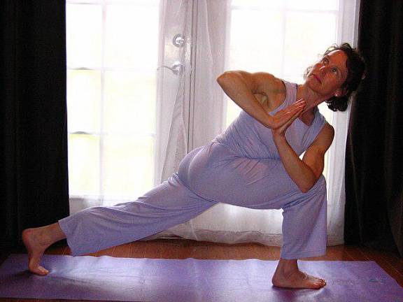 This woman is engaged in a form of lunge, which is one of four routines that AARP says can be combined with three other exercise routines to reap the same benefits as running a mile.