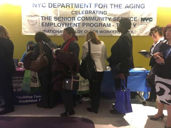 While waiting to speak with employers, program participants learn about other social support programs offered by city agencies. Photo: Megan Conn
