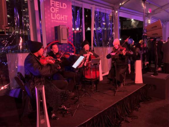 A chilly string quarter entertained guests at the launch party for the Field of Light in the construction site that Soloviev Group has renamed Freedom Plaza, which opened to the public Dec. 15. Photo: Keith J, Kelly