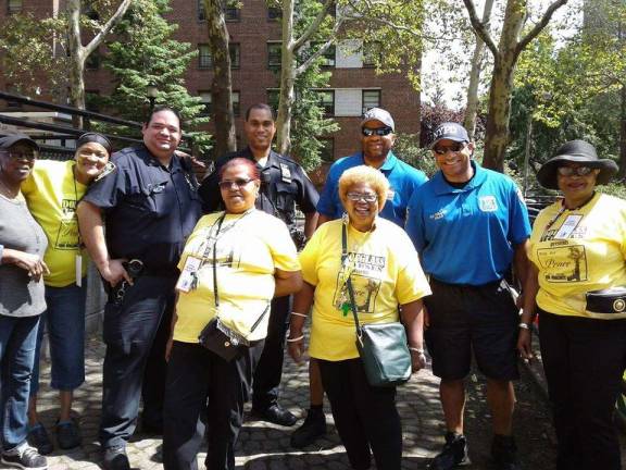 Carmen Quinones (first row at right), shown here with tenants and cops at the Frederick Douglass Houses in Manhattan Valley. Photo courtesy of Carmen Quinones