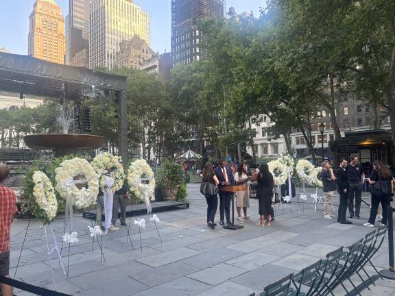 Wreaths of white roses are set up at an interfaith prayer memorial in Bryant Park on July 29 for the victims of the attack in midtown Manhattan a day earlier.