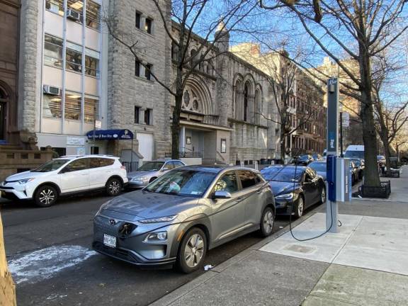 Electric vehicle charging ports, unheard of on the street only a few years ago, are likely to become more numerous in the future as electric vehicle use climbs in urban environments.