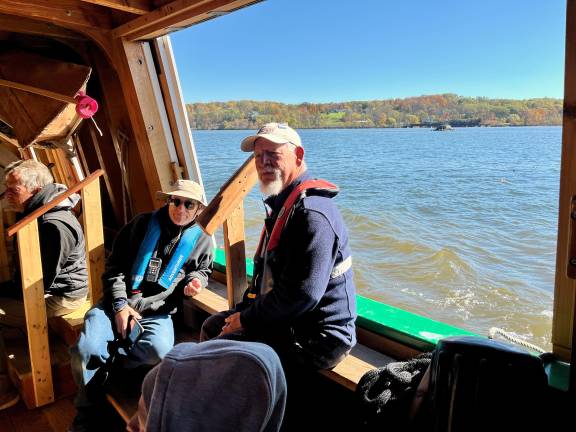 Staffers from the Buffalo Maritime Center take a break on the new Seneca Queen as it’s propelled down the Hudson River from the Erie Canal enroute to a berth in Manhattan.