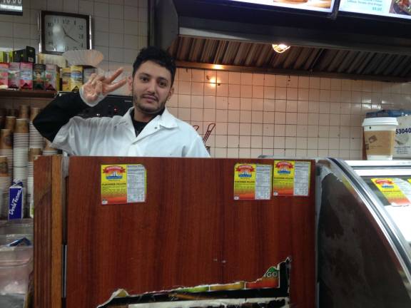 Osama Khalid, who works at the West Side Stop One deli on Amsterdam Avenue, was finalizing U.S. passport applications for his two daughters, who are in Yemen, when President Trump earlier this month signed an executive order barring travel from that country and six others. Photo: Richard Khavkine