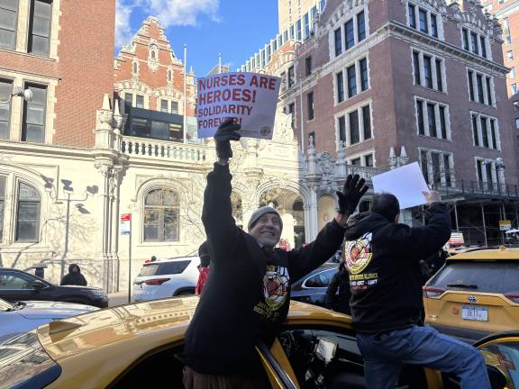 Several members of the cab drivers union parked their cars alongside the picket line with signs saying, “Nurses Are Heroes! Solidarity Forever!”