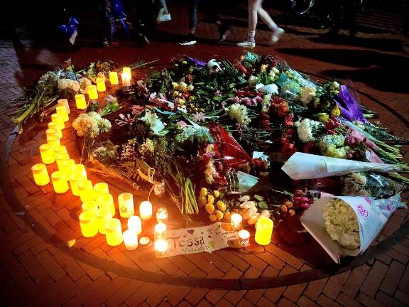 A makeshift memorial of flowers and candles at the main gate of Barnard.