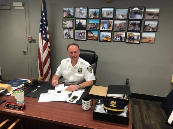 Deputy Inspector Neil Zuber, commanding officer of the 20th Pct. has travelled to all seven continents with his detective wife Leiddy and proudly has the pictures of their travels in seven columns of pictures behind his desk at his precinct office on W. 81st St.