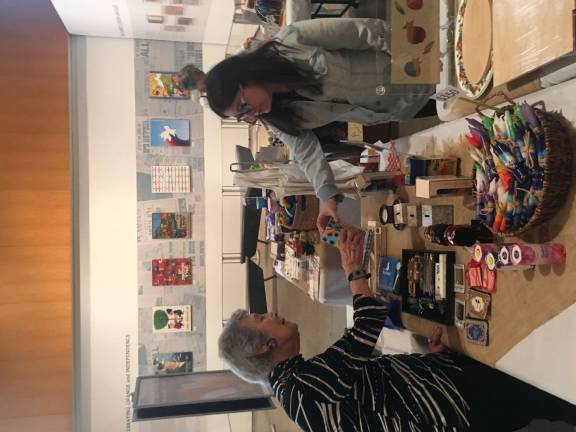 Just One Job participant Emily Mann selling merchandise to a customer of the JCC's Shabbat Shop.&#xa0;Photo: Michael Rock