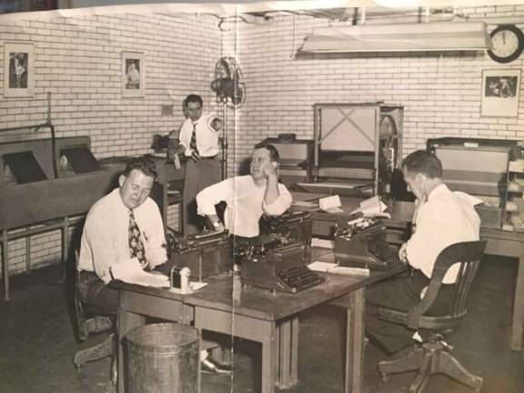 No, it&#x2019;s not the set of a movie, it&#x2019;s the City Room of the Daily News in the early 1950s, complete with pencil sharpeners and manual typewriters. At rear (pointing) is longtime press agent, publicist and political fixer Morty Matz, then an assistant picture assignment editor at The News. Photo: Collection of Morty Matz