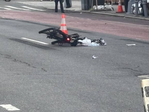 The red light on the rear of the e-bike continued to stay illuminated after the bike was struck by a late-model Nissan SUV. The driver, who fled, was later arrested, while the 65-year old e-bike rider suffered serious head trauma.