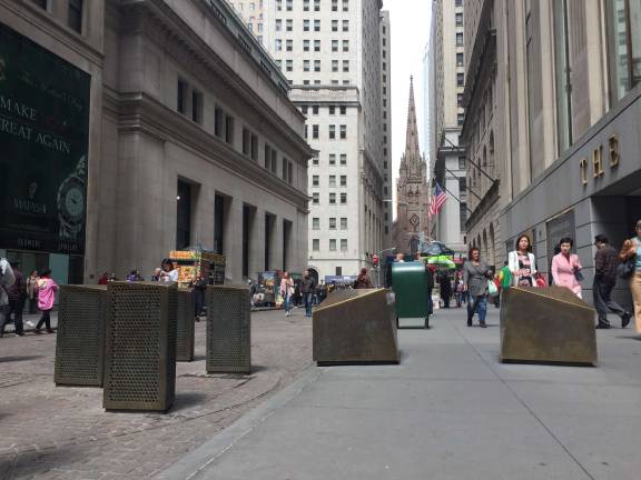 Imposing barricades at entrances to Wall Street would be replaced with less obtrusive bollards under a new plan proposed by Downtown Alliance. Photo: Michael Garofalo