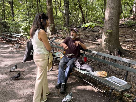 Israel Ortiz speaks with parkgoers near his usual bench on Central Park West, where visitors often stop to watch him interact with wildlife.