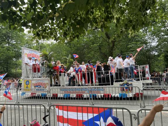 With a backdrop of leafy Central Park, A mambo float brings music, dance, and lively vibes to Fifth Avenue.
