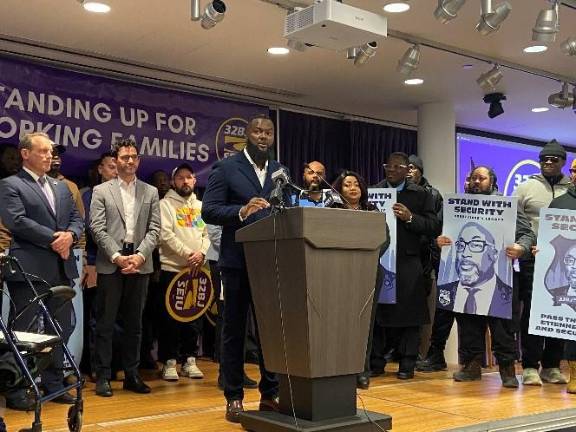Smith Etienne, brother of the slain security guard Aland Etienne spoke at a press conference supporting the bill named for his brother.