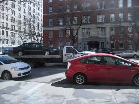 This flatbed truck, hauling an automobile atop its chassis, was photographed by a resident of West End Avenue at 92nd Street as it headed northbound on the evening of Sunday, March 25. The vehicleisn't supposed to be driving up the largely residential avenue and appears to be violating city rules barring commercial traffic on the stretch. Photo: Courtesy of West End Preservation Society