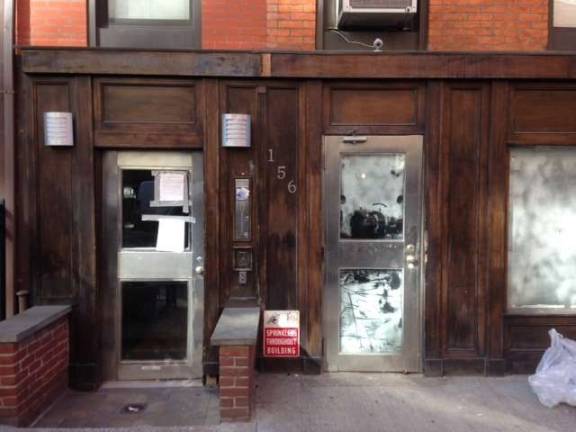 156 West 15th Street, which officials say was being operated as an illicit hotel through Airbnb listings, is now entirely vacant, and court and other notices are plastered throughout its hallway entrance. Photo: Clarrie Feinstein