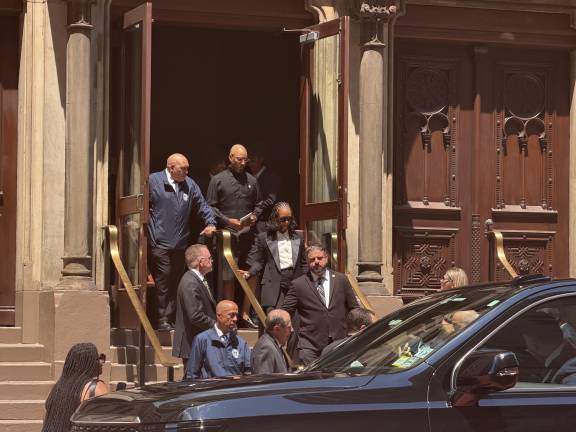 Musicians Alicia Keys and her husband Swizz Beatz leaving the synagogue with their two sons close behind.