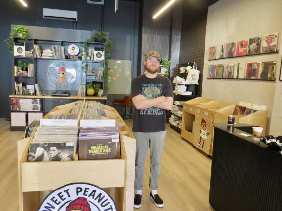 Proud owner Hunter Brammer stands in the middle of Sweet Peanut Nutters. John Lewis and Sascha Distel, the Fall and the Velvet Underground are among the jewels on the wall.