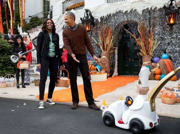 Then-President Barack Obama and first lady Michelle Obama welcomed children during a Halloween event on the South Lawn of the White House in October 2015. The former first couple are looking to purchase a residence in New York City. Photo: Pete Souza, official White House photographer