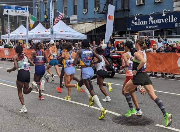 Helen Obiri (far left, bib #103) runs a tactical race heading up First Ave, but then sprinted the last 400 yds in Central Park to win the women’s division. Photo: Brian Berger
