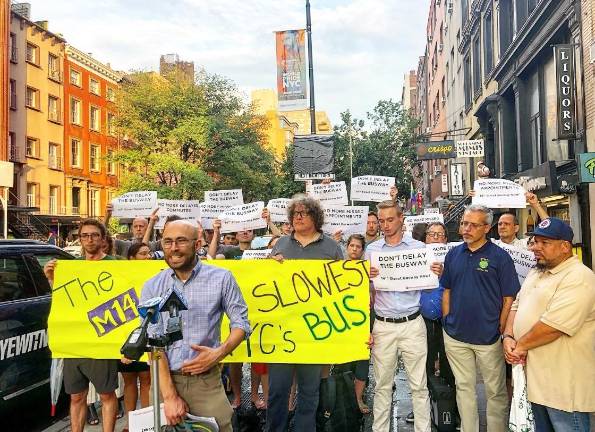 Danny Pearlstein speaks during a rally advocating for the 14th Street busway, saying the plan’s opponents want to protect their “mansion life.” Photo: Emily Higginbotham