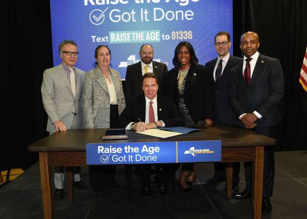 Flanked by supporters and several Manhattan elected officials, Gov. Andrew Cuomo signed legislation on Monday raising the age of criminality in New York from 16 to 18, which was approved when the state budget passed on Sunday.&#xa0;Photo:&#xa0;Kevin P. Coughlin/Office of the Governor