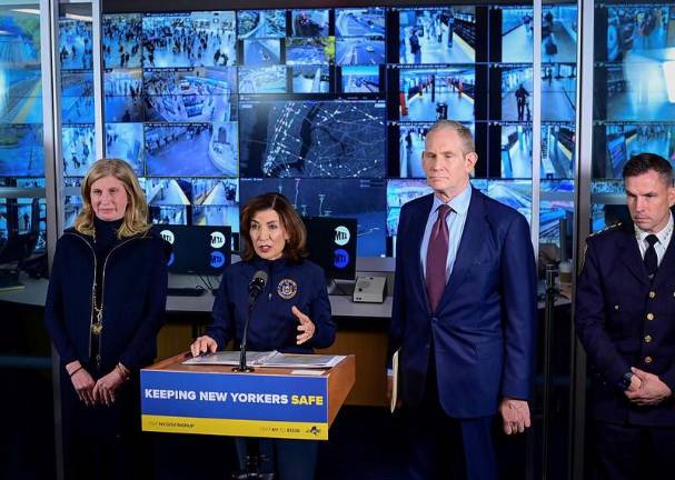 A grim-faced Governor Kathy Hochul (at mic), flanked by NYPD Commissioner Jessica Tisch (left) and MTA Chairman and CEO Janno Leiber (second from right), demanding that Homeland Security disburse the $34 million earmarked for counterterrorism in the MTA. Of the 21 applicants for the funds, the MTA was the only one that the feds held back.