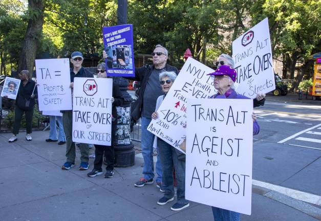 Members of NYC E-Vehicle Safety Alliance protesting in front of the Transportation Alternatives annual fundraiser on June 1, pushing against the proposal for a two-way bike lane on West 72 Street.
