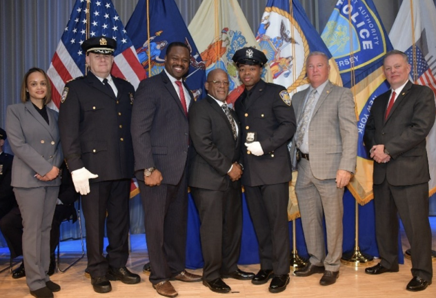 Port Authority Police Department rookie Keith Walcott Jr. (third from right) receives the shield worn by his father, Keith Walcott Sr. (fourth from right) during the annual badge ceremony held days before the official graduation from the academy.