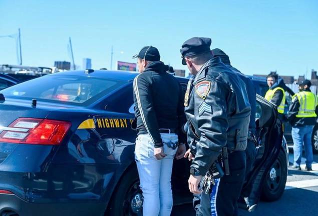 <b>As part of the multi-agency sweep on March 11 on the Robert F Kennedy Bridge, this car owner was arrested for fraudulent license plate use, one of the eight people arrested during the 8-hour operation at the Lincoln Tunnel, George Washington Bridge and the the RFK Bridge.</b> Photo: MTA