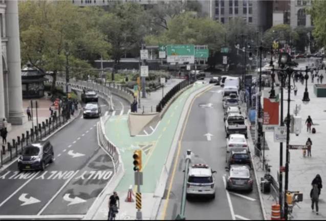 DOT rendering of 2026 Brooklyn Bridge bike lane plan; note absence of e-bikes, scooters, mopeds in the rendering.