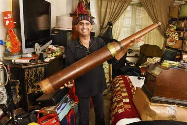 Denny Daniel with a telescope from the mid-1800s. Photo: Bob Krasner