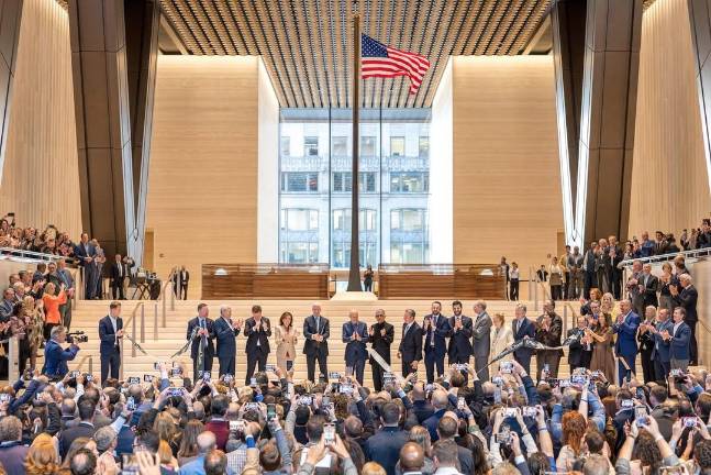 The ribbon cutting with Lord Norman Foster flag installation waving behind.