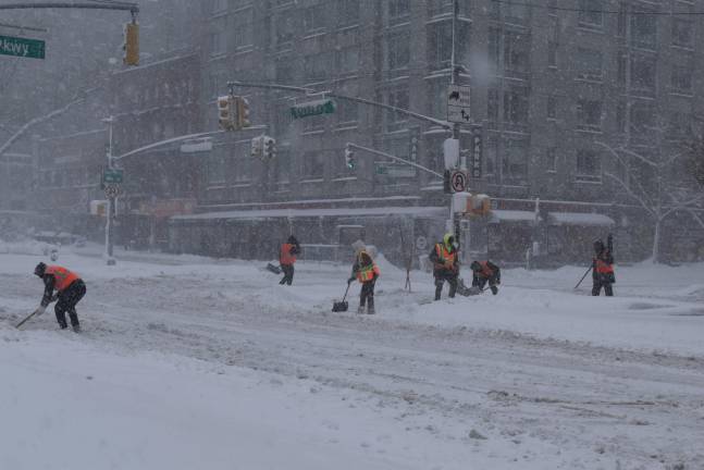 Even as snow fell on Feb. 22, an army of workers cleared walkways. Mayor Mamdani was criticized by some after the Jan. 24 storm for not clearing sidewalks and intersections fast enough.