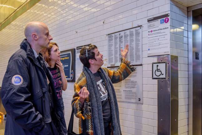 Jennifer Bartlett (right) points out an elevator sign that needs some tweaking as activist Jessica Murray and NYCT President Andy Byford look on. Photo: Erik McGregor