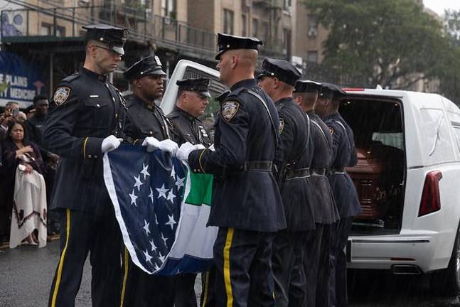 The flag is folded to present to the family of Police Officer Didarul Islam following his funeral in the Bronx on July 31. He was one of four slain in the midtown tower massacre on July 28.